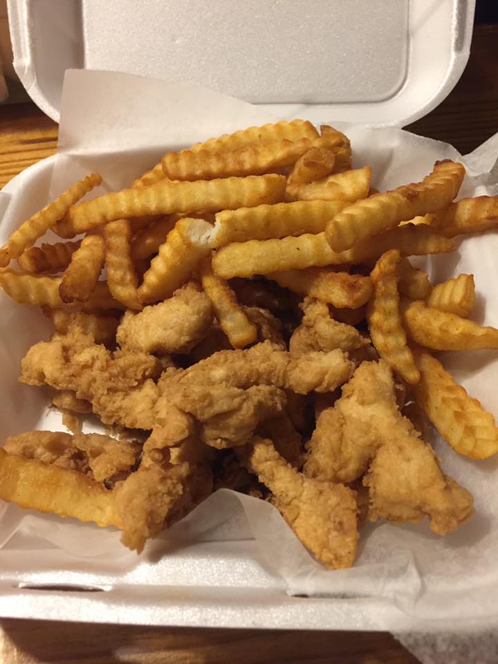 Golden fried chicken tenders with a large helping of fries.