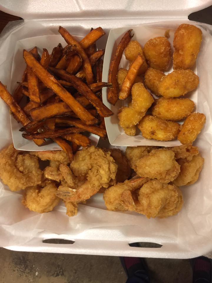 Large golden fried shrimp with sweet potato fries, and golden fried corn nuggets.